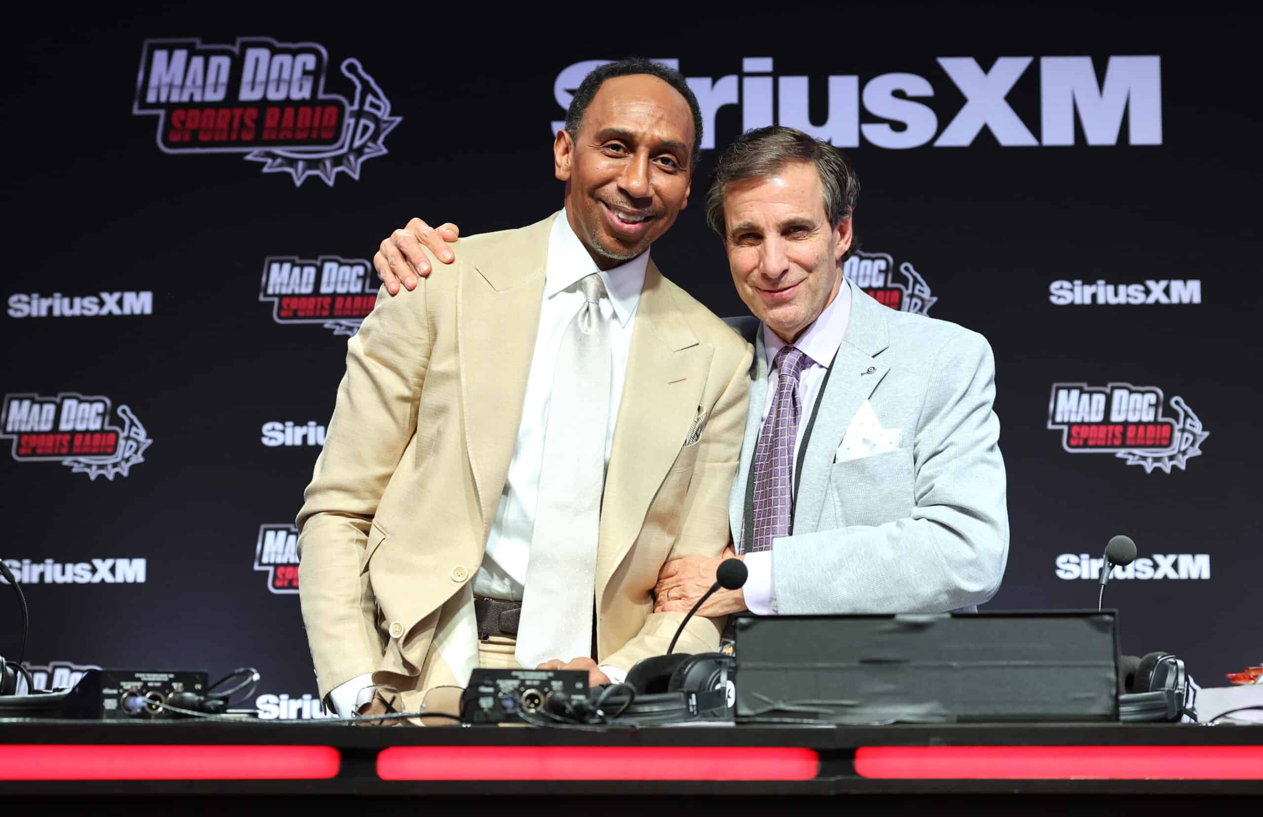 LAS VEGAS, NEVADA - FEBRUARY 07: (L-R) Stephen A. Smith and Chris "Mad Dog" Russo speak on SiriusXM at Super Bowl LVIII on February 07, 2024 in Las Vegas, Nevada.